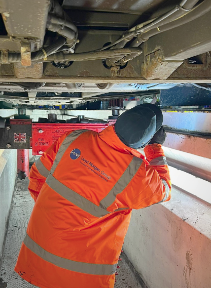 Person in high vis inspecting a vehicle